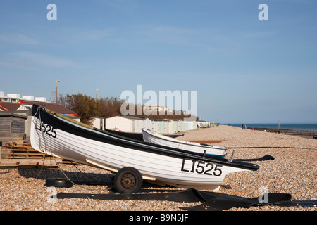 Aldwick Bognor Regis West Sussex England UK View along pebbled beach with boats and beach huts on south coast Stock Photo