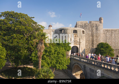 Tourists and visitors stroll outside though the Pile Gate in the walled city of Dubrovnik in summer sunshine Dalmatian Coast Cro Stock Photo