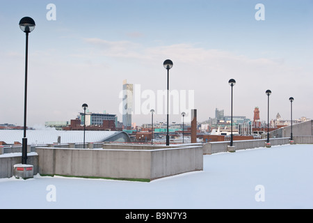 View from car park roof into Manchester centre on snowy day in winter with Hilton Tower Beetham tower in background Stock Photo