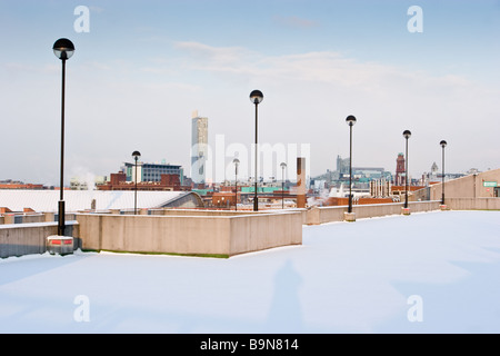 View from car park roof into Manchester centre on snowy day in winter with Hilton Tower Beetham tower in background Stock Photo