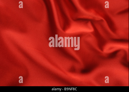 red satin background A satiny fabric with beautiful light shadow waves Stock Photo