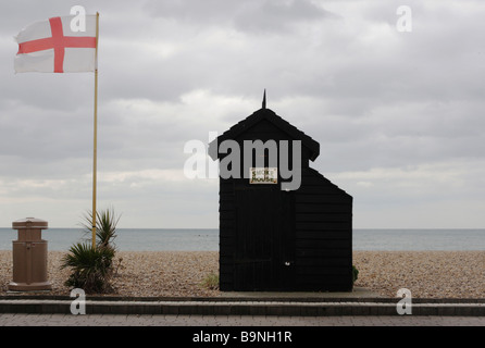 Traditional smokehouse for smoking fish and an England flag on Brighton beach Stock Photo