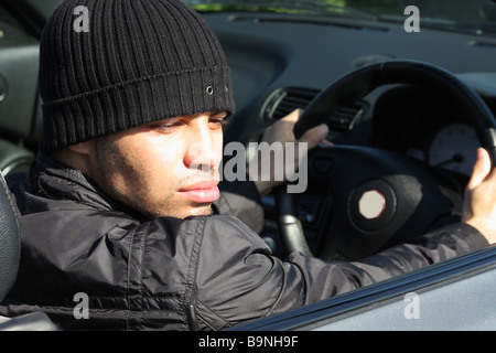 Young professional footballer Ben Fairclough driving a convertible car. Stock Photo