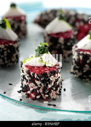Beetroot risotto cakes with goats cheese and salsa verde Stock Photo