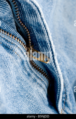 Macro of a brass zipper on blue jeans Stock Photo