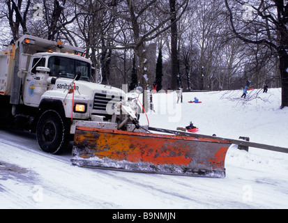 Snow plow in Central Park New York City. Sanitation Department road maintenance after a winter heavy snowstorm. NYC USA Stock Photo