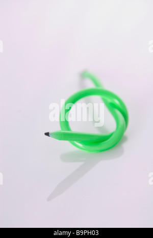 Green flexible pencil with a knot on a white background Stock Photo
