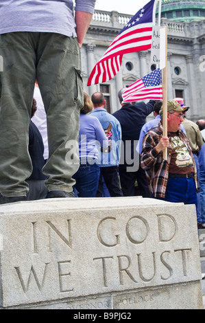 anti  spending tax protest tea party Harrisburg PA , demonstrator, In God We Trust, USA american flag Stock Photo