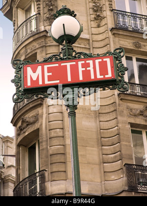 Iconic Metro underground sign with building in the background, Paris France Stock Photo