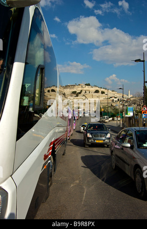 Long line of parked tour buses waiting for tourists and pilgrims outside southern walls of old Jerusalem city Stock Photo