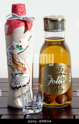 A bottle of Korean Wild Ginseng Wine & Seoljungmae Gold (made of plum) with real gold powder (dust) inside.on the table. Close u Stock Photo