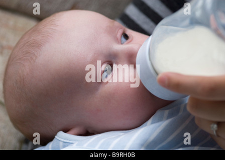 Six week old baby boy being fed with a bottle Stock Photo