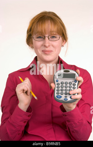 A woman has just made a calculation on a calculator and seems pleased ...