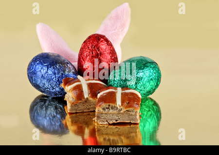 Bunny ears chocolate eggs and hot cross buns for easter Stock Photo