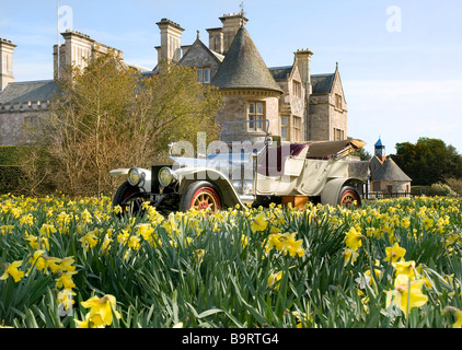 1909 Rolls Royce Silver Ghost outside Palace House, Beaulieu with daffodils. Stock Photo