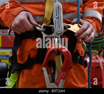 Member of an urban search and rescue team checks his equipment Stock Photo