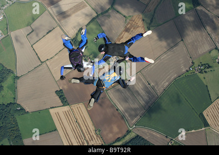 Three skydivers doing formations in mid-air Stock Photo