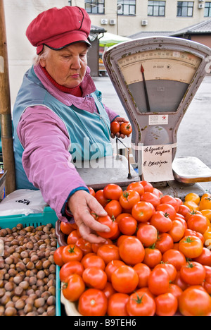 Woman selling tomatoes in a street market, Riga, Latvia, Europe Stock Photo