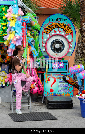 Carnival midway GUESS YOUR WEIGHT OR booth Stock Photo - Alamy