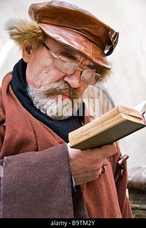 Man reading a book in the street, Riga, Latvia, Europe Stock Photo