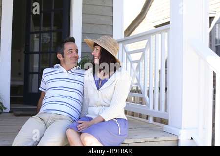 Couple sitting on porch together Stock Photo