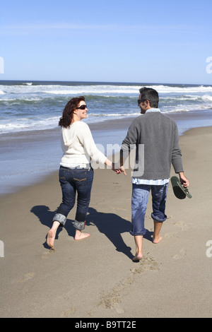 Young couple walking on beach Stock Photo