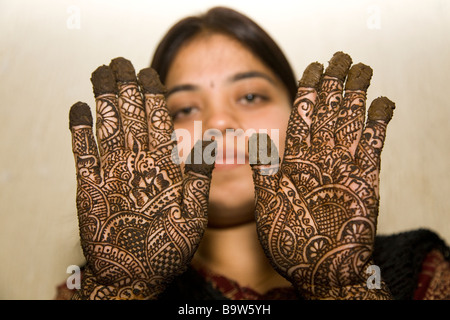 A bride's best friend shows off the fresh henna patterns on her hands. Stock Photo