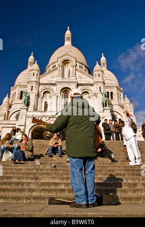 Street musician playing in front of the Sacre Coeur Basilica, Montmartre, Paris, France, Europe Stock Photo