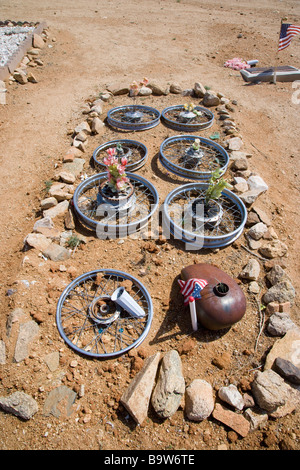 Desert graveyard with grave showing the remains of a Harley Davidson motorbike, Chloride, Arizona, USA Stock Photo