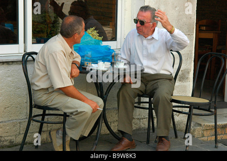 Two friend talking at bar in Gjirokaster Albania Stock Photo