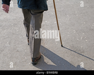Elderly walker with walking stick Stock Photo