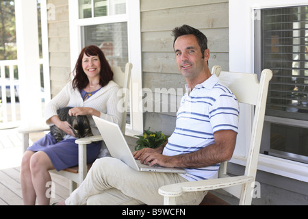 Couple sitting on porch Stock Photo