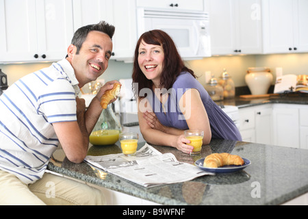 Couple having breakfast in kitchen Stock Photo