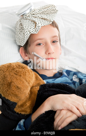 Sick little boy home from school with a fever Vertical view  Stock Photo
