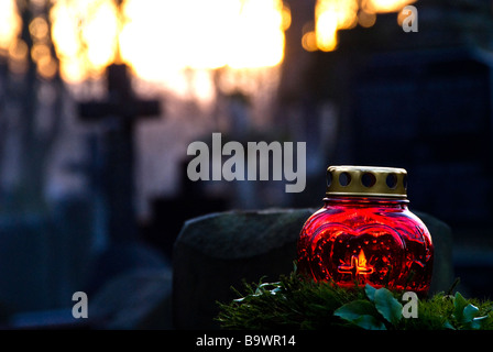 Candle on a grave during the celebration of the All Saint´s Day in the Powazki cemetery, Warsaw, Poland, Europe. Stock Photo