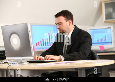 Businessman working at office desk Stock Photo