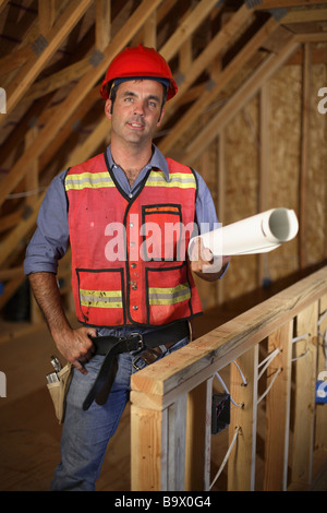 Construction worker holding plans Stock Photo