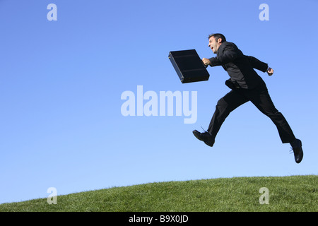 Businessman outdoors jumping Stock Photo