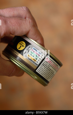 Food contents label showing Calories Sugar Fat Saturates and Salt quantities on a tin of salmon labelling Stock Photo