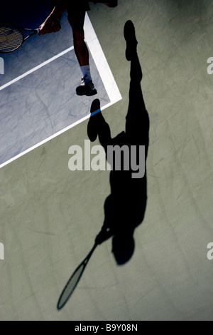 Shadow of tennis player in action Stock Photo