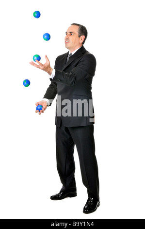 Business man in suit juggling planet earth balls Stock Photo