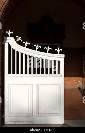 white gate, left side of double gates, topped with fleur-de-lys Stock Photo