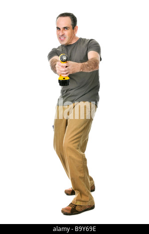 Fierce handyman aiming his cordless drill like a gun Stock Photo