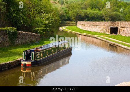 A Narrow Boat moored on the Peak Forest Canal at Bugsworth Basin in Derbyshire Stock Photo