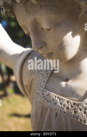 Angle shaped old headstone of a grave carved from marble Stock Photo