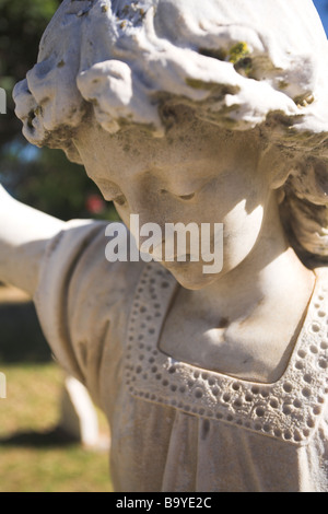 Angle shaped old headstone of a grave carved from marble Stock Photo