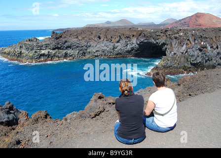 Sea caves on rocky coast at Los Hervideros, near El Golfo, Lanzarote, Canary Islands, Spain Stock Photo