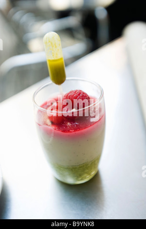 Almond mousse with pistachio coulis and berries Stock Photo