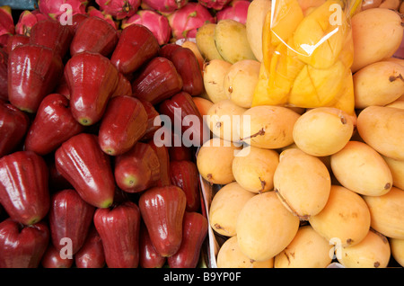 Close up of Red pear apples and ripe yellow mangoes on a Bangkok street stall Stock Photo