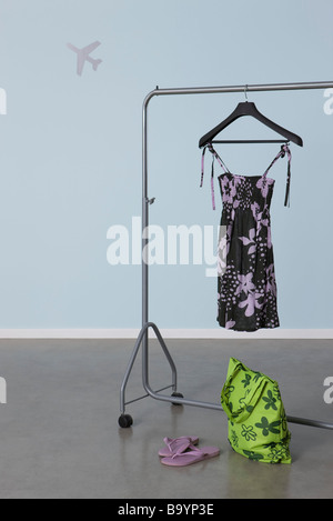Summery woman's outfit on clothes rack, plane image in background Stock Photo